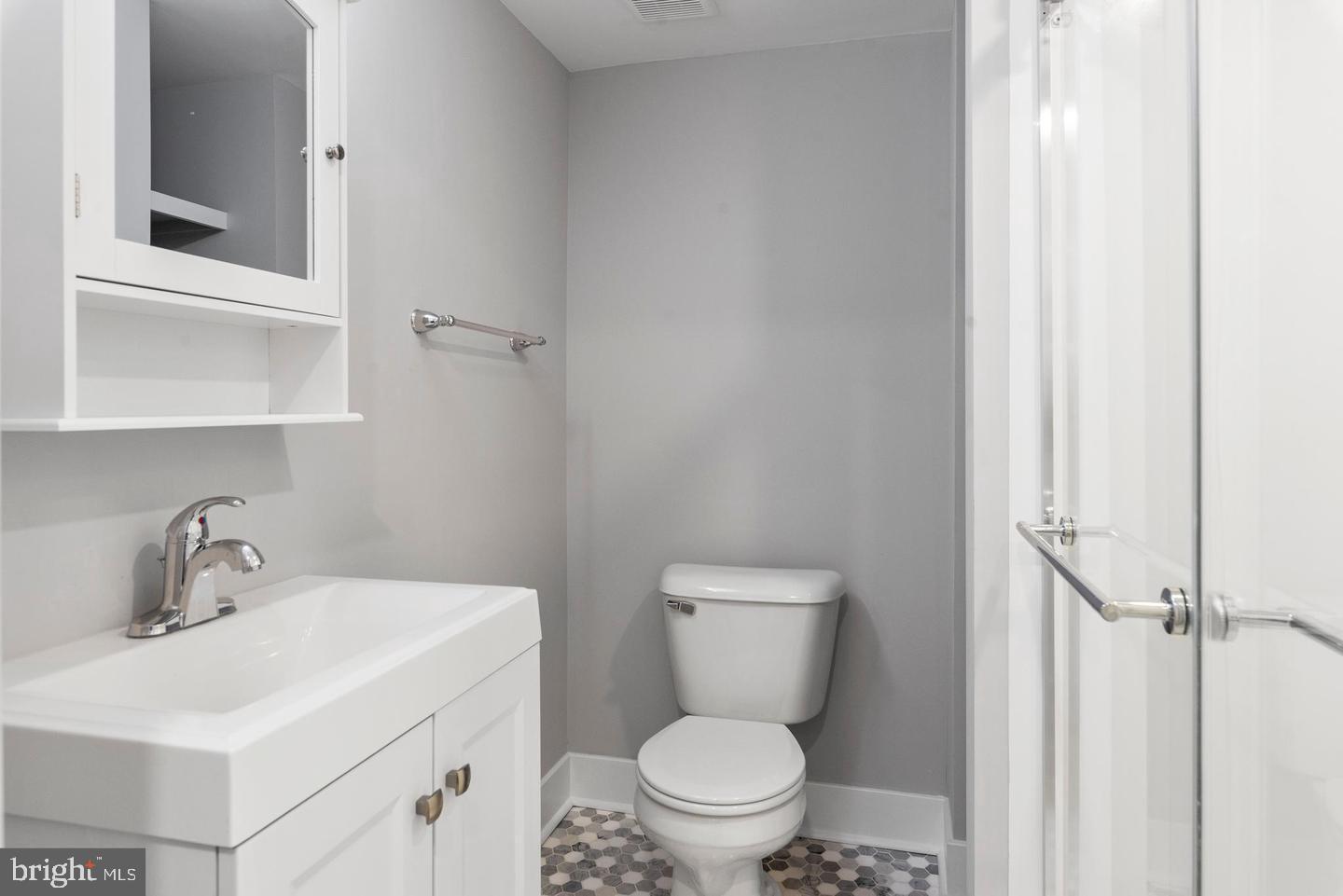 256 South 11th Street, Unit 2 Philadelphia, PA 19107 - Photo 11 of 13 a bathroom with a toilet a sink and mirror