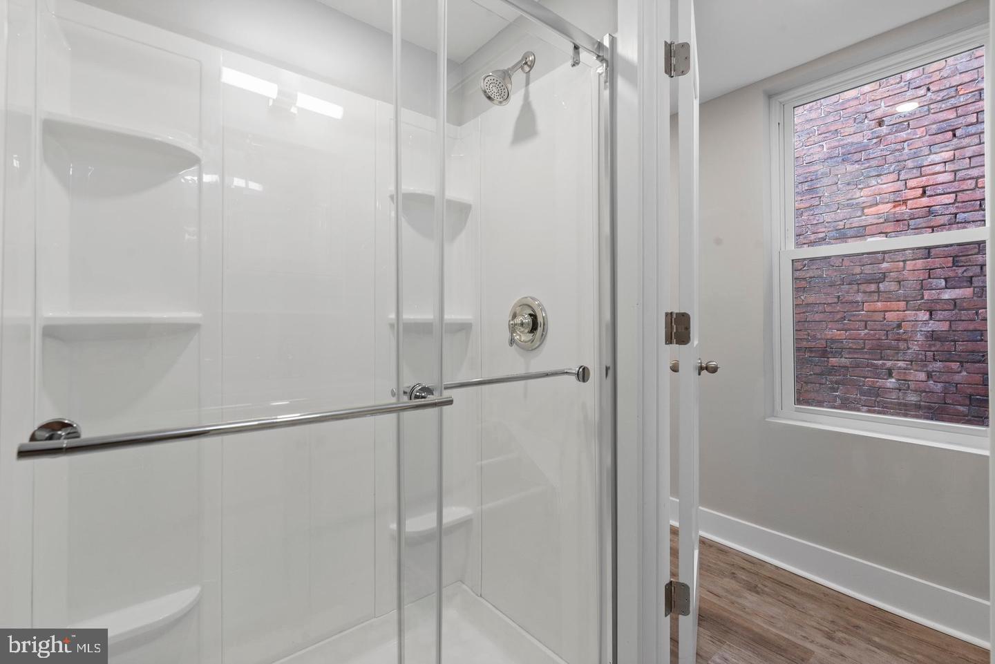 256 South 11th Street, Unit 2 Philadelphia, PA 19107 - Photo 12 of 13 a bathroom with a shower and a glass door