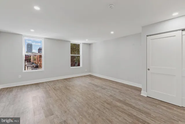 wooden floor in an empty room with a window