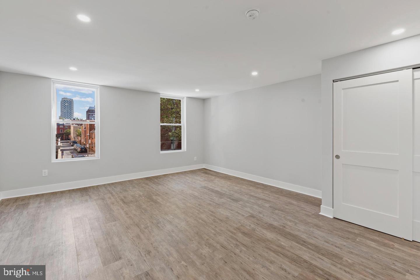 256 South 11th Street, Unit 2 Philadelphia, PA 19107 - Photo 3 of 13 wooden floor in an empty room with a window
