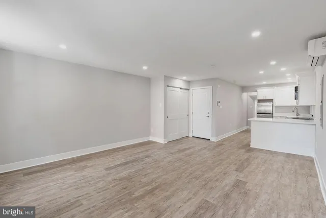 a view of a kitchen with a sink and a refrigerator