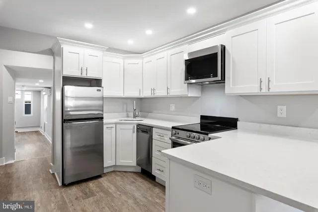 a kitchen with a white stove top oven and refrigerator
