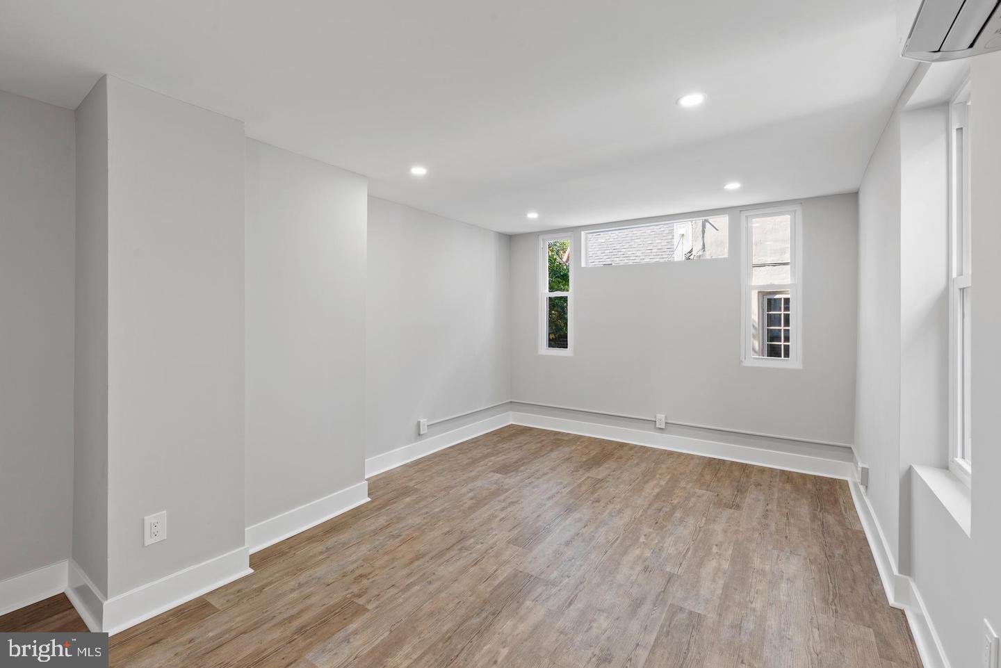 256 South 11th Street, Unit 2 Philadelphia, PA 19107 - Photo 10 of 13 an empty room with wooden floor and windows