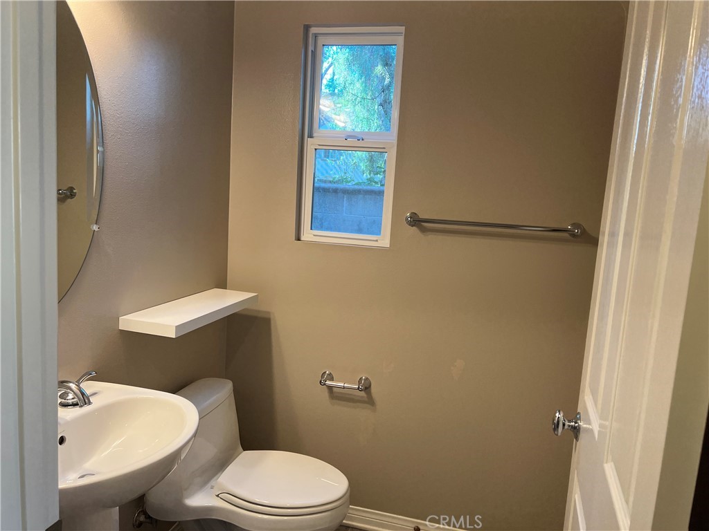 2 Inglenook Irvine, CA 92602 - Photo 7 of 18 a white toilet sitting next to a bathroom sink