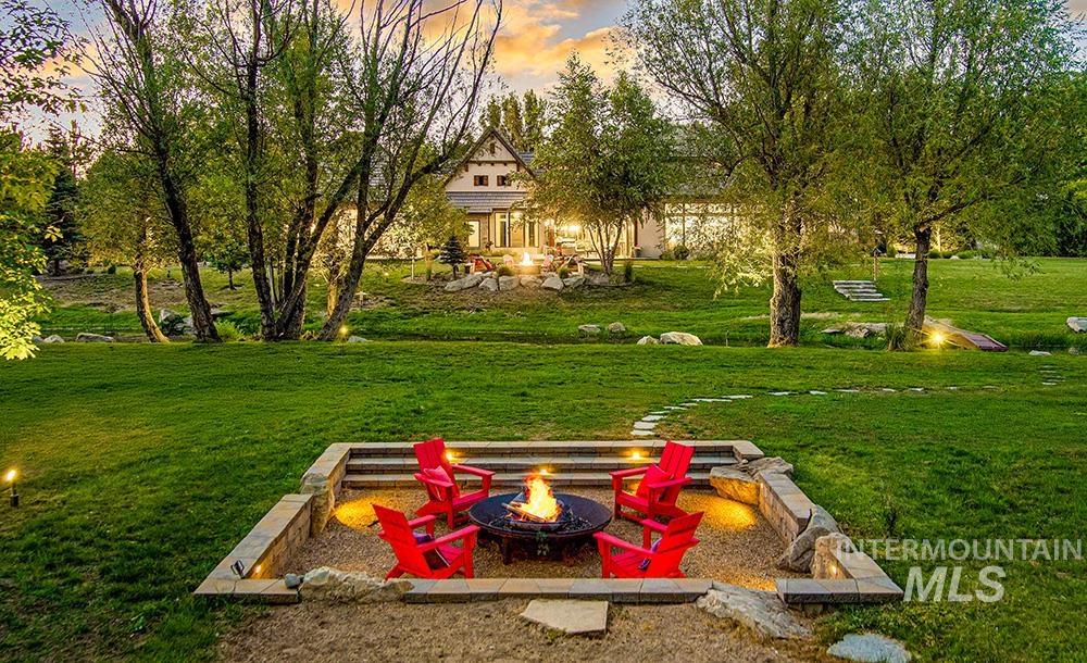1582 East Rivers End Court Eagle, ID 83616 - Photo 43 of 49 Yard at dusk with a fire pit and a lawn