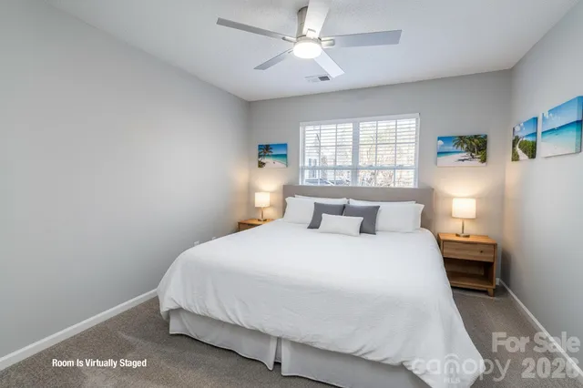 an empty room with a window and a fan