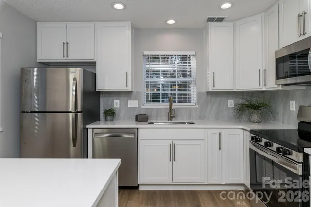 a view of a bedroom with a bed and a chandelier