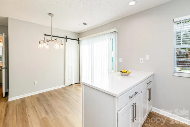 a living room with furniture a flat screen tv and a dining table