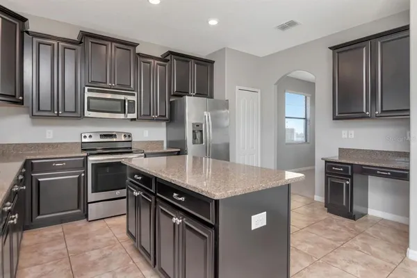 a kitchen with a sink stove and refrigerator