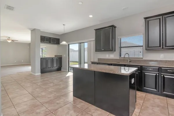 a kitchen with granite countertop a sink and a stove top oven