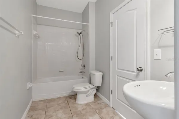 a bath room with a toilet sink shower and a bath tub