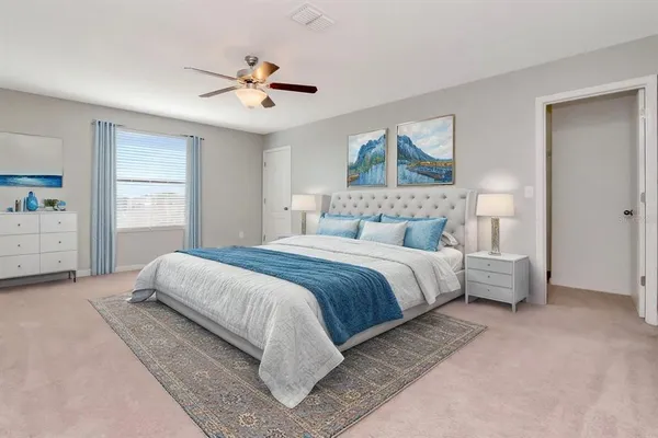 a bedroom with a large bed and a window
