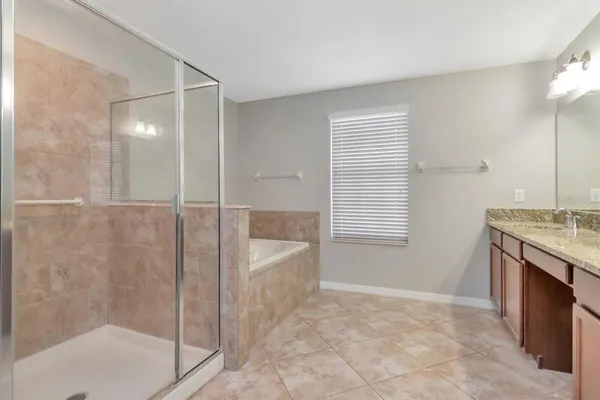 a spacious bathroom with a granite countertop sink a toilet and shower