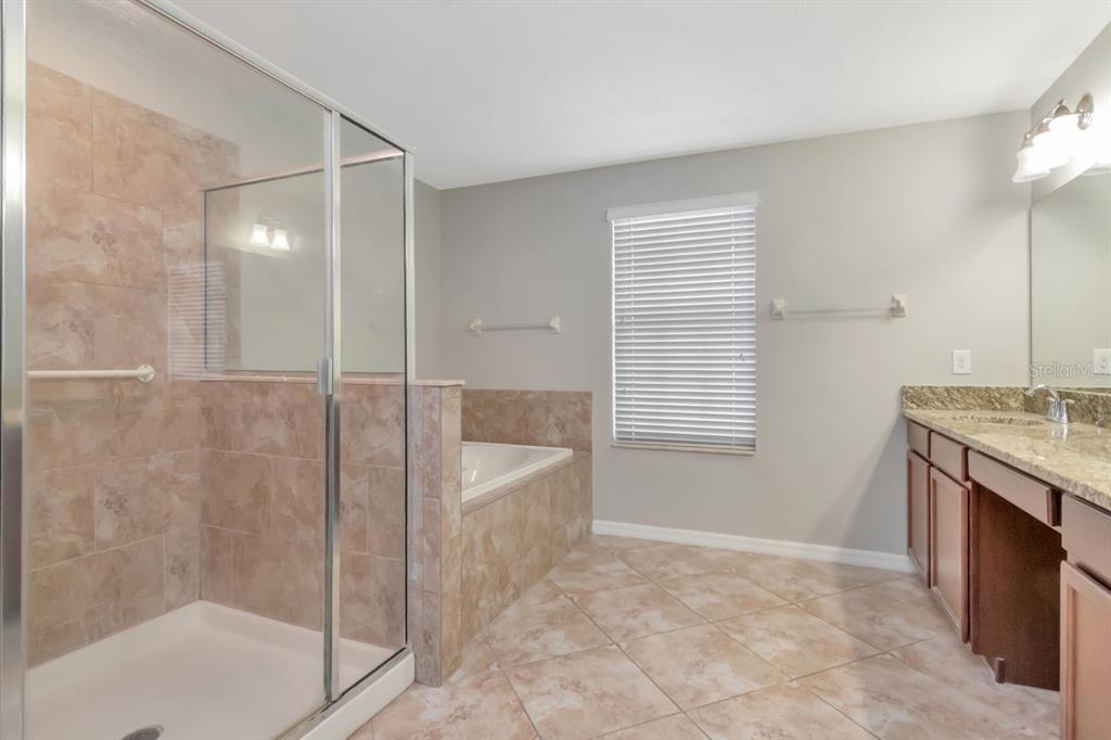 13939 Felix Will Road Riverview, FL 33579 - Photo 23 of 47 a spacious bathroom with a granite countertop sink a toilet and shower