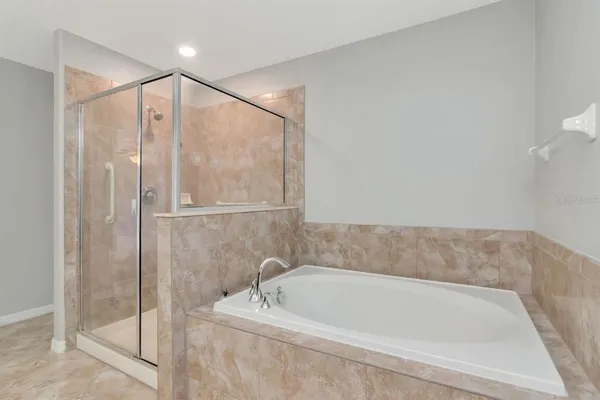 a bathroom with a tub and shower
