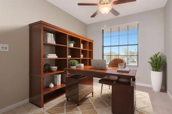 a work room with furniture and a potted plant