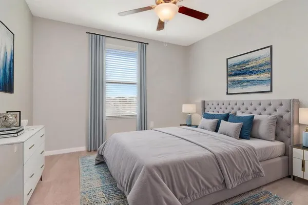 a bedroom with a bed and a window