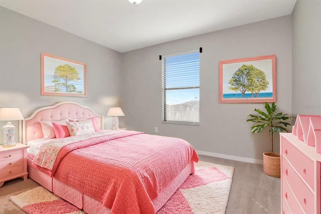 13939 Felix Will Road Riverview, FL 33579 - Photo 29 of 47 a bedroom with bed and a potted plant