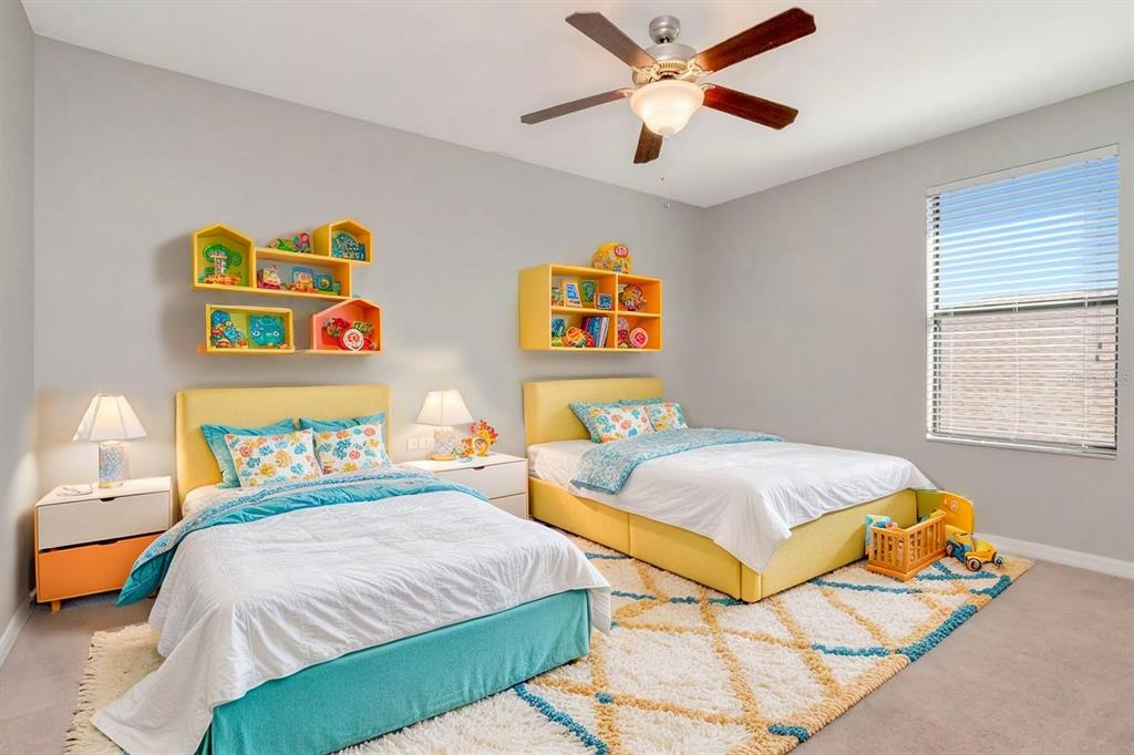 13939 Felix Will Road Riverview, FL 33579 - Photo 31 of 47 a bedroom with a bed and a chandelier