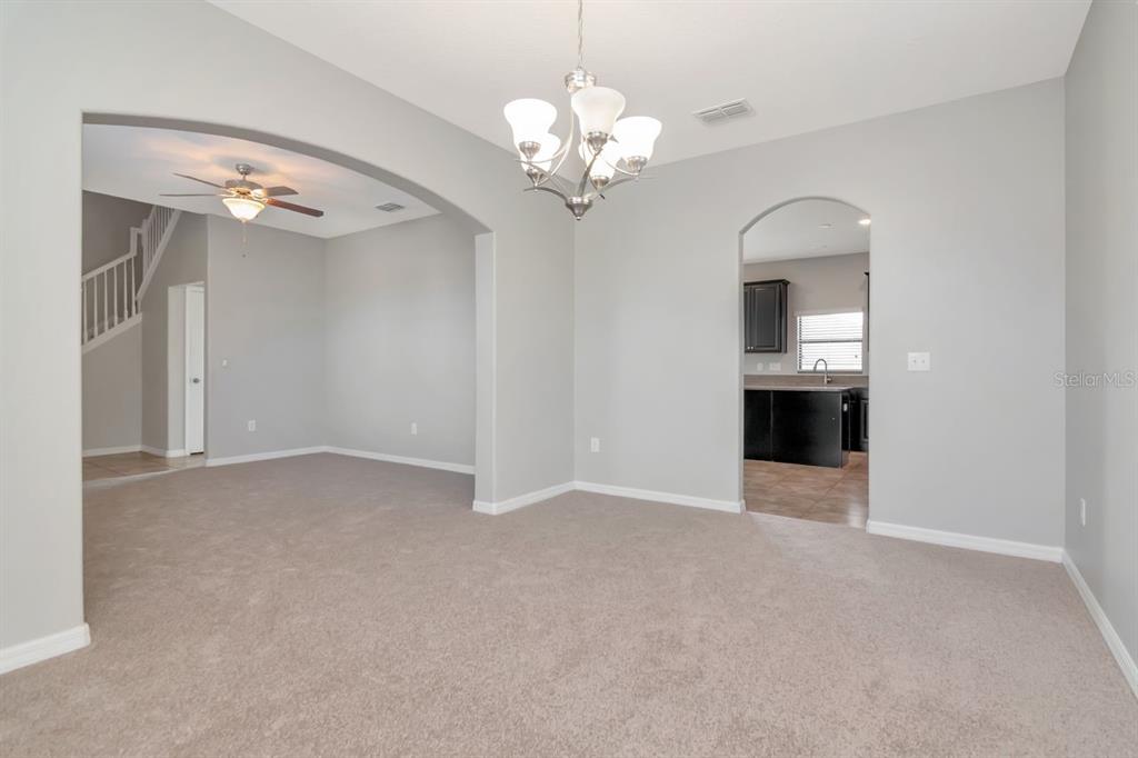 13939 Felix Will Road Riverview, FL 33579 - Photo 6 of 47 a view of an empty room with a chandelier fan
