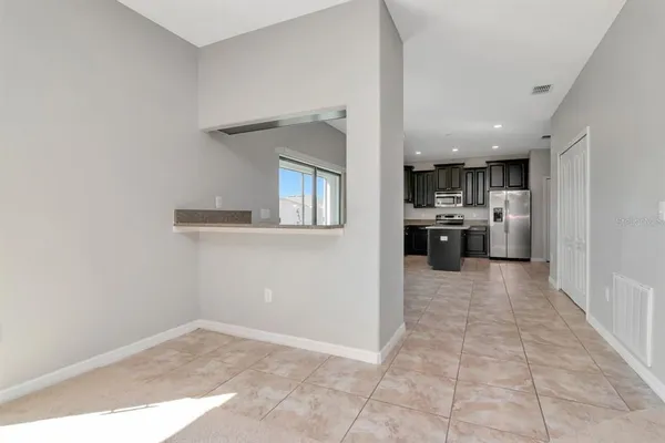 a view of a kitchen with a sink and a refrigerator