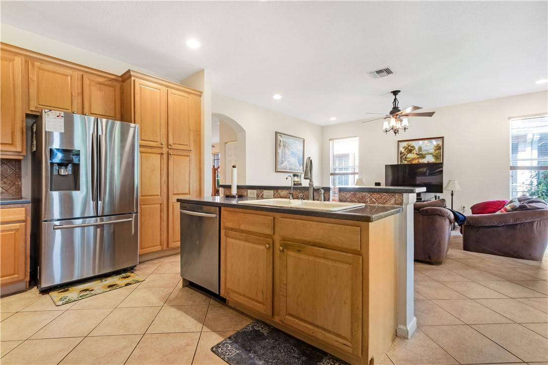 4611 Southwest 131st Terrace Miramar, FL 33027 - Photo 12 of 66 a kitchen with stainless steel appliances granite countertop a refrigerator sink and stove