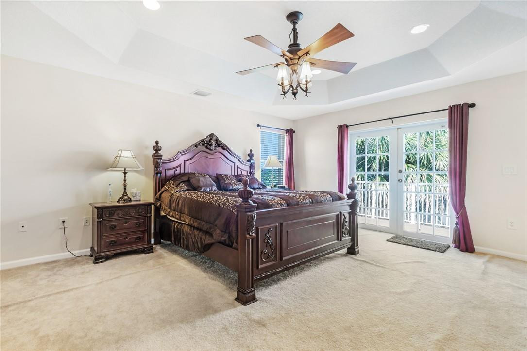 4611 Southwest 131st Terrace Miramar, FL 33027 - Photo 16 of 66 a spacious bedroom with a bed and a chandelier