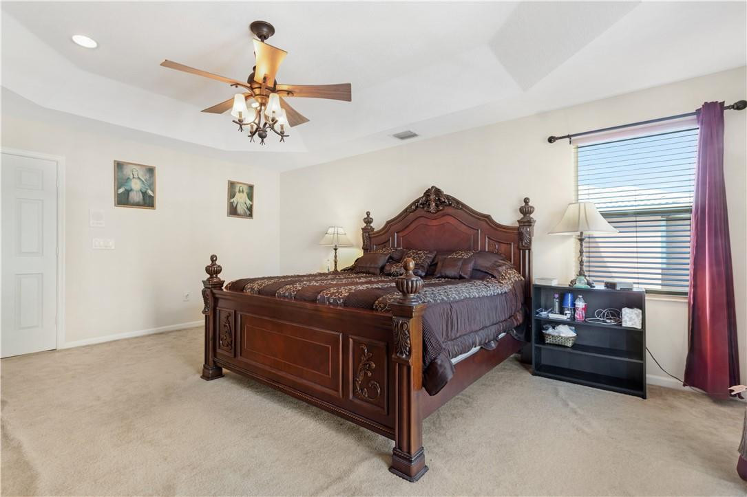 4611 Southwest 131st Terrace Miramar, FL 33027 - Photo 17 of 66 a bed room with a bed and a chandelier