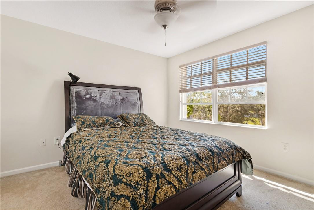 4611 Southwest 131st Terrace Miramar, FL 33027 - Photo 21 of 66 a bed sitting in a bedroom next to a window