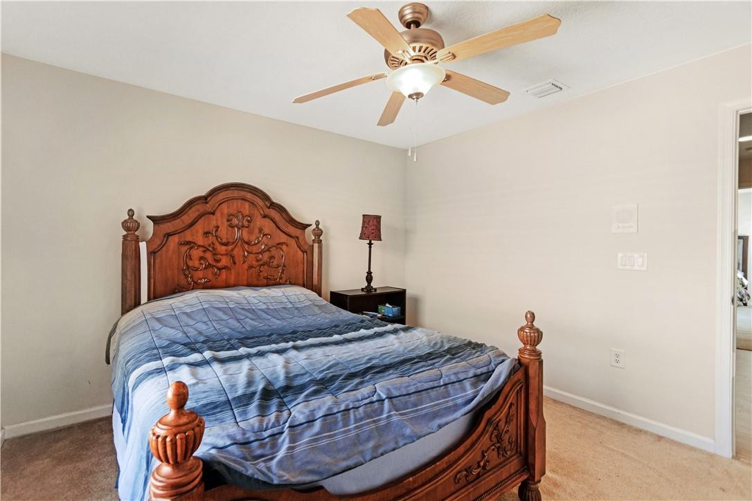 4611 Southwest 131st Terrace Miramar, FL 33027 - Photo 24 of 66 a bedroom with a bed and a chandelier