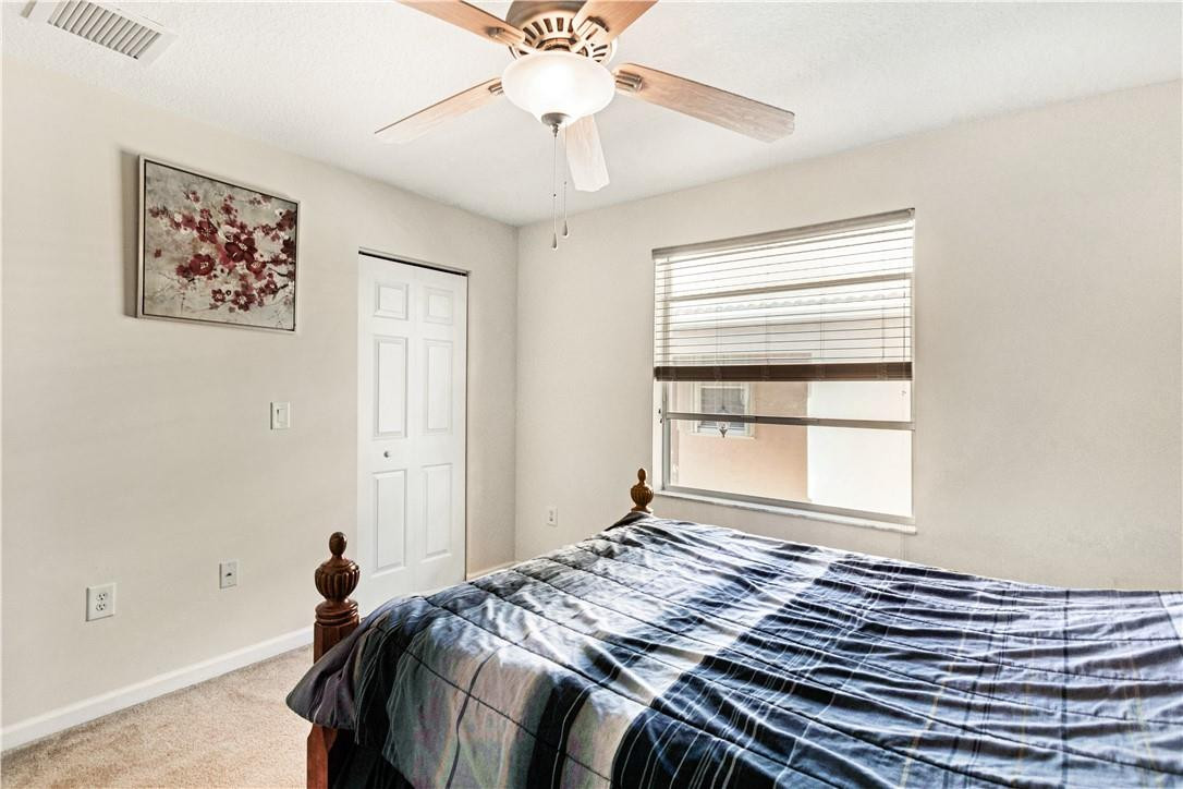 4611 Southwest 131st Terrace Miramar, FL 33027 - Photo 25 of 66 a bed sitting in a bedroom next to a window