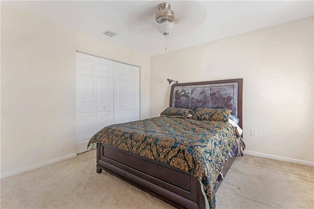 4611 Southwest 131st Terrace Miramar, FL 33027 - Photo 27 of 66 a bed sitting in a bedroom next to a cabinet