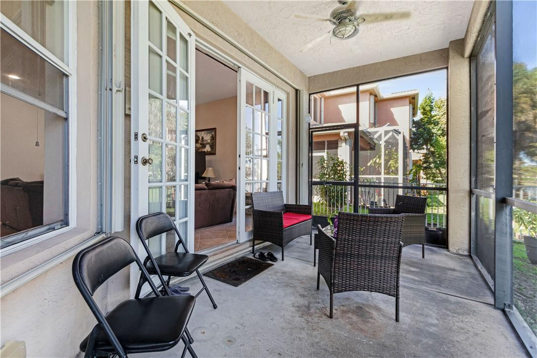 4611 Southwest 131st Terrace Miramar, FL 33027 - Photo 42 of 66 a living room with furniture and floor to ceiling windows