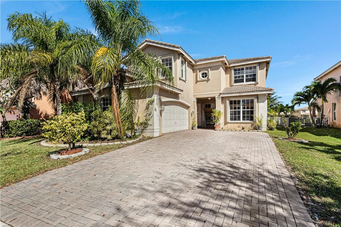4611 Southwest 131st Terrace Miramar, FL 33027 - Photo 49 of 66 a front view of a house with a yard