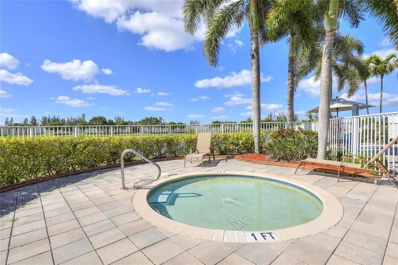 4611 Southwest 131st Terrace Miramar, FL 33027 - Photo 56 of 66 a view of a swimming pool with a table and chairs