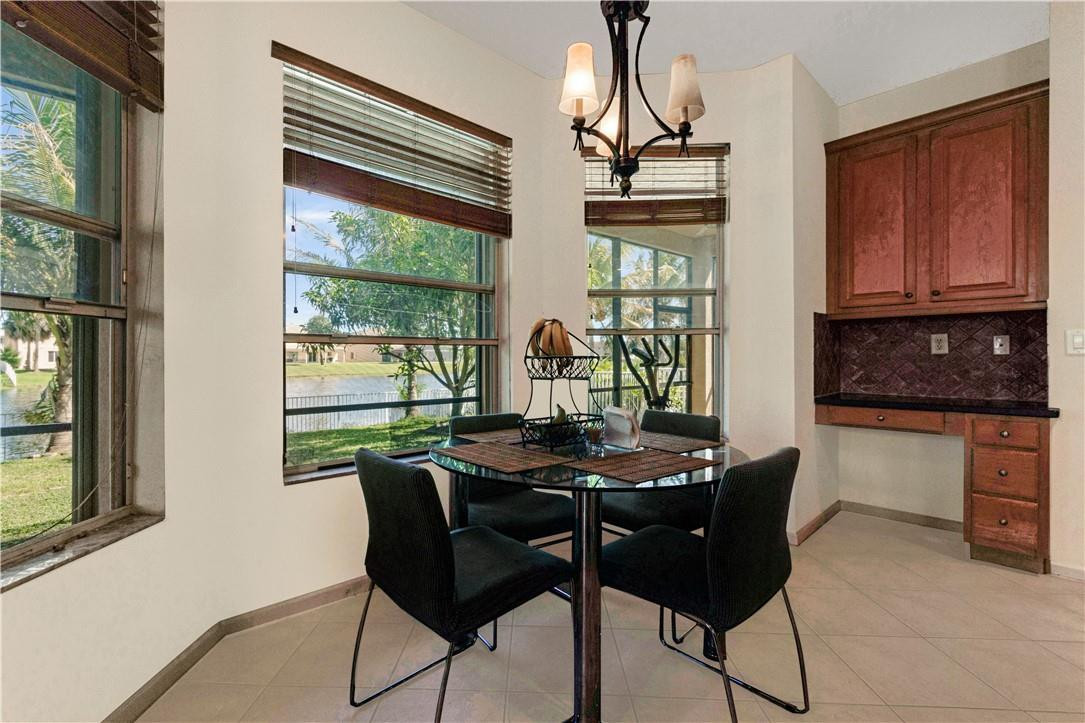 4611 Southwest 131st Terrace Miramar, FL 33027 - Photo 9 of 66 a dining room with furniture and window