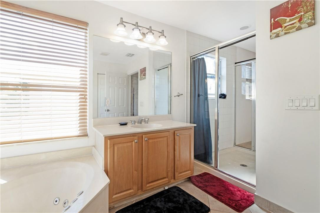 4611 Southwest 131st Terrace Miramar, FL 33027 - Photo 10 of 66 a bathroom with a tub sink and mirror