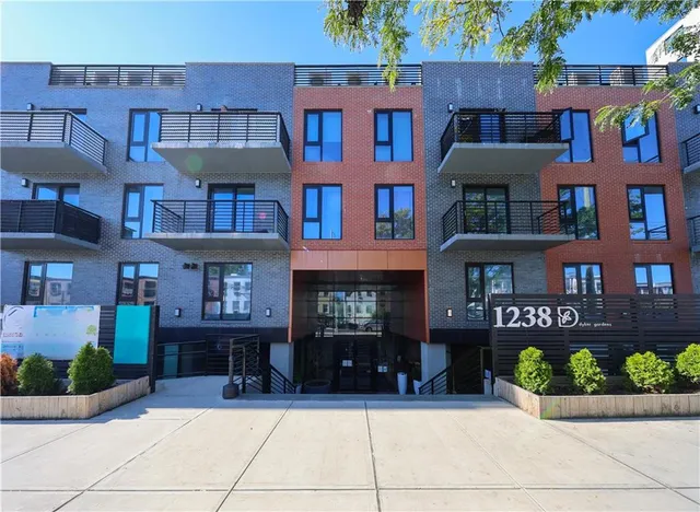 a front view of a brick building with many windows