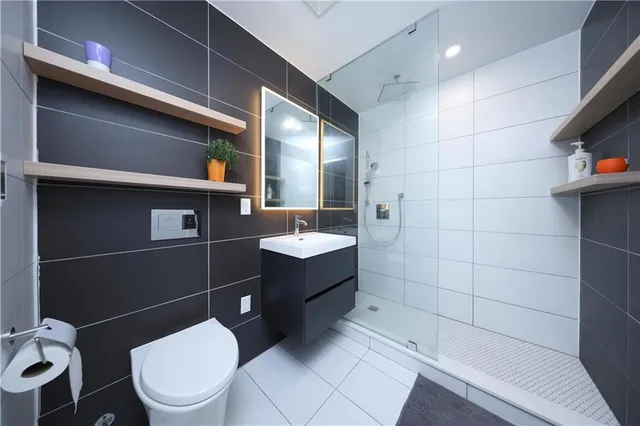 a bathroom with a toilet and a shower