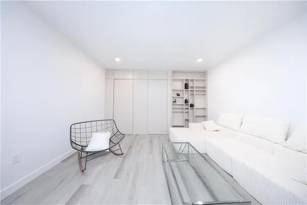 a room with a bed and a wooden floor