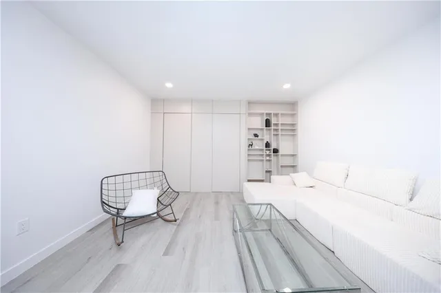 a room with a bed and a wooden floor