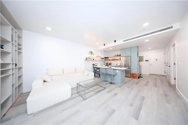 a view of a living room kitchen and a sink