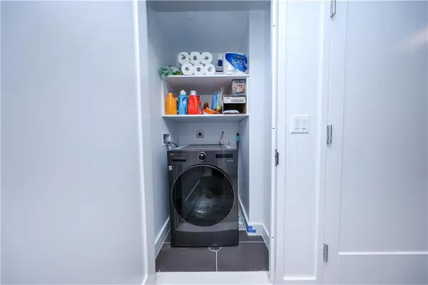 a view of a bedroom with washer and dryer