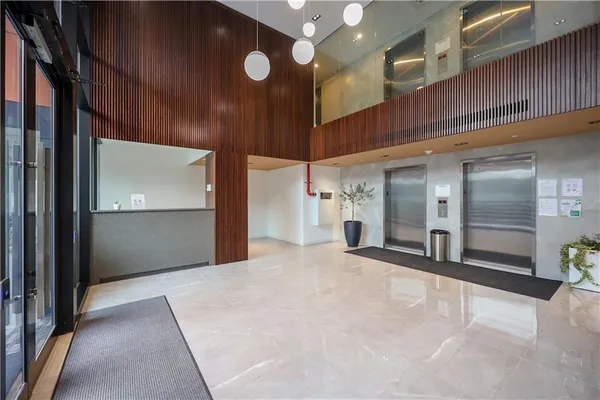 a view of a hallway with stainless steel appliances