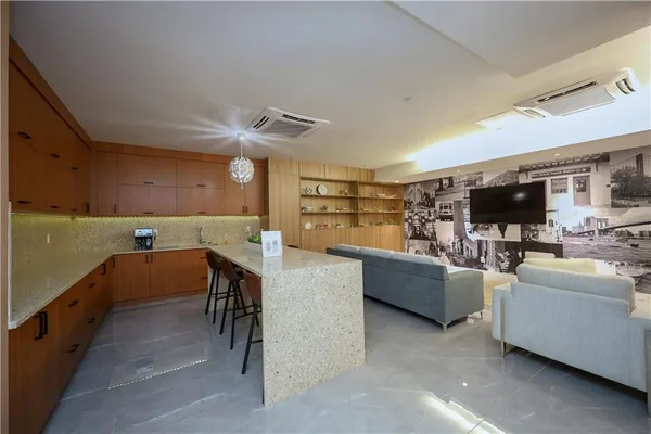 a view of living room kitchen with furniture and flat screen tv