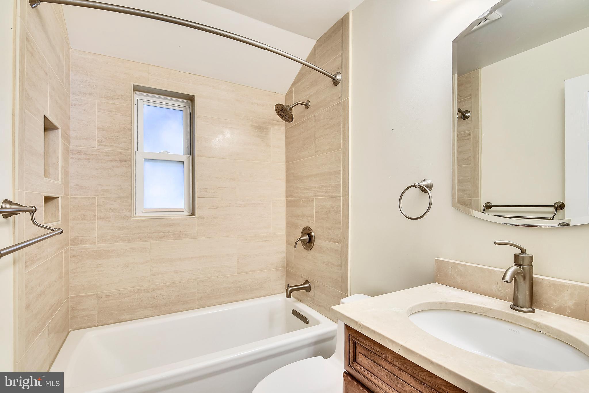 3006 Weller Road Silver Spring, MD 20906 - Photo 17 of 18 a bathroom with a granite countertop sink toilet and shower