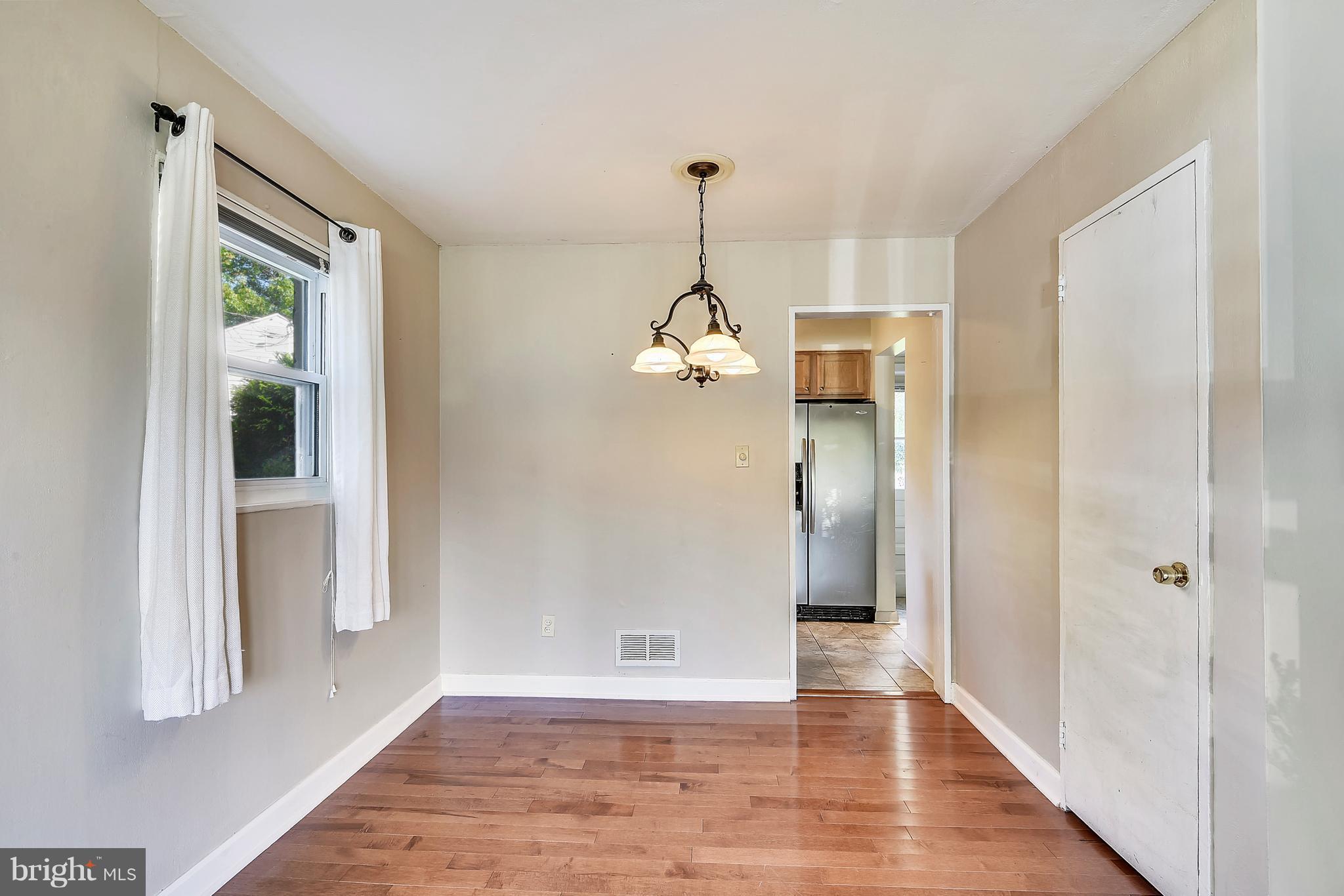 3006 Weller Road Silver Spring, MD 20906 - Photo 7 of 18 a view of a hallway with wooden floor and a cabinet