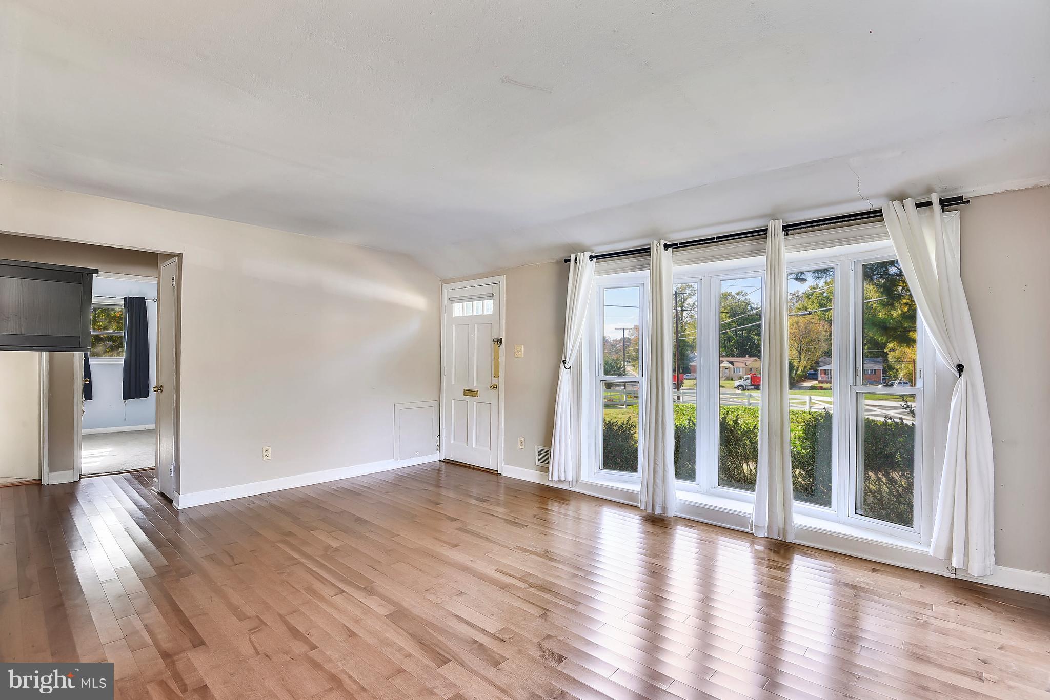 3006 Weller Road Silver Spring, MD 20906 - Photo 9 of 18 wooden floor in an empty room with a window