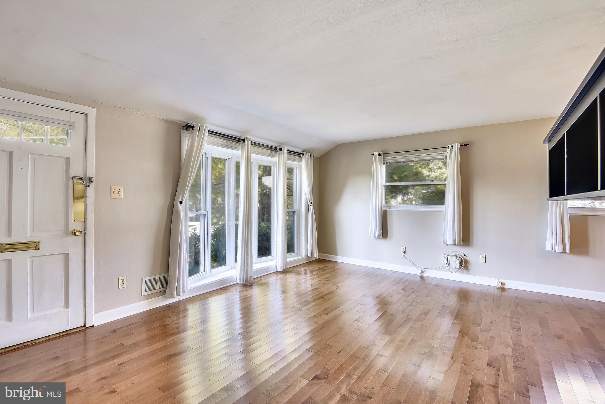 3006 Weller Road Silver Spring, MD 20906 - Photo 10 of 18 an empty room with wooden floor and windows
