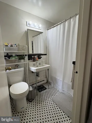 a bathroom with a toilet a sink and a shower
